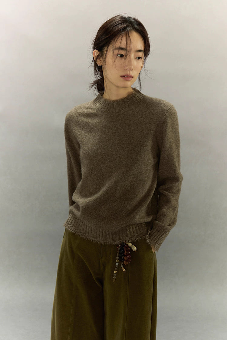 Model wearing light coffee brown yak wool sweater with soft high neck and relaxed fit.