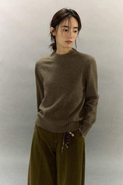 Model wearing light coffee brown yak wool sweater with soft high neck and relaxed fit.