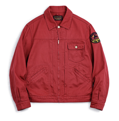 lat lay of men’s rust red rodeo jacket showing patch and front pockets