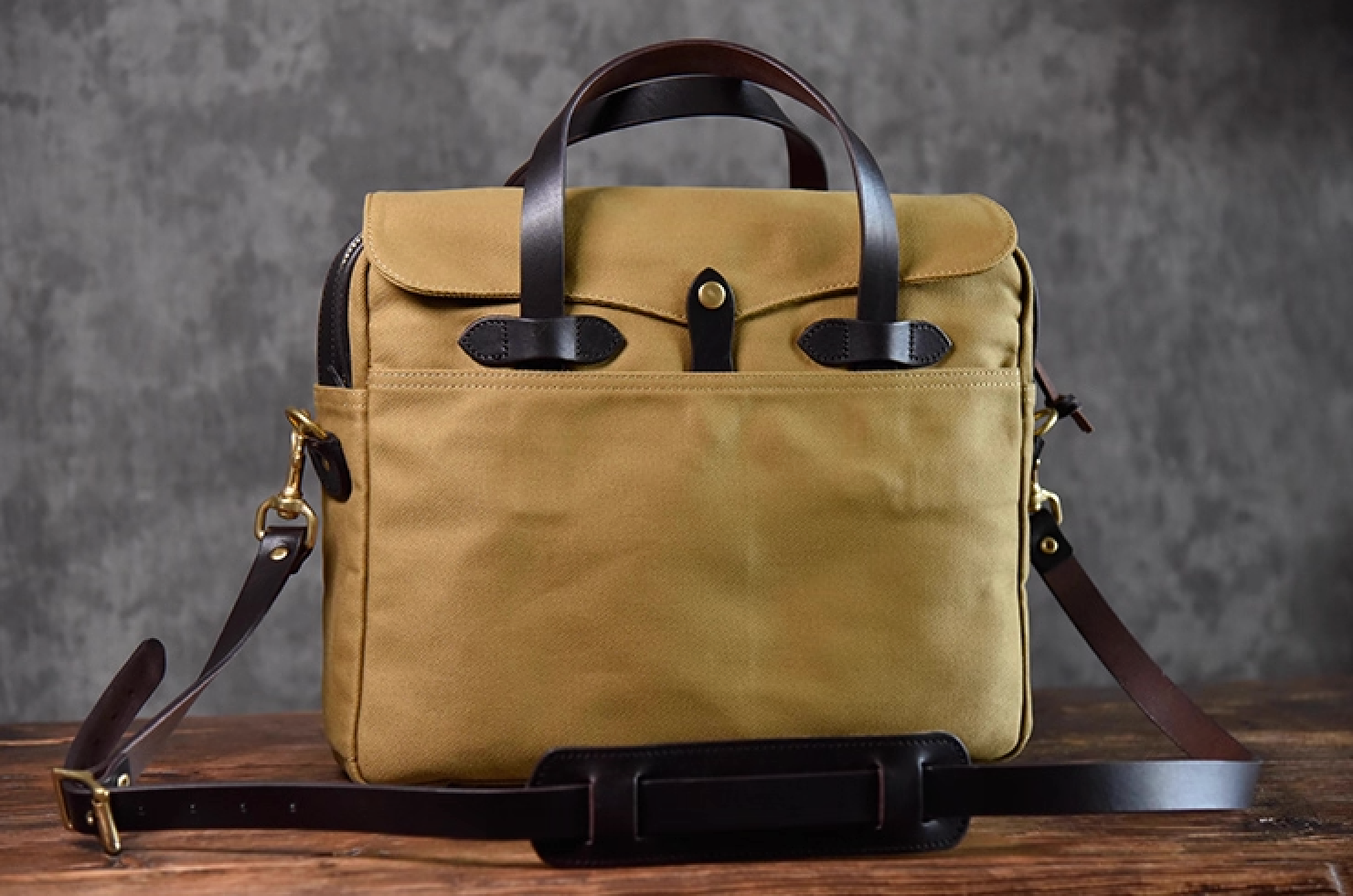 Front view of khaki waxed canvas briefcase with full-grain leather handles