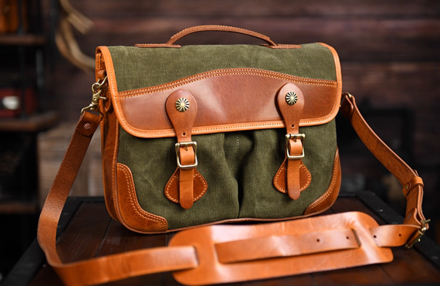 Angled view showing vintage leather and waxed canvas messenger bag