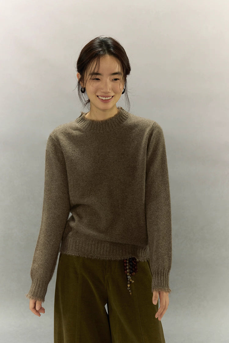 Woman smiling in light coffee brown yak wool sweater, showing cozy and soft texture.