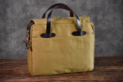 Front view of khaki waxed canvas briefcase with full-grain leather handles