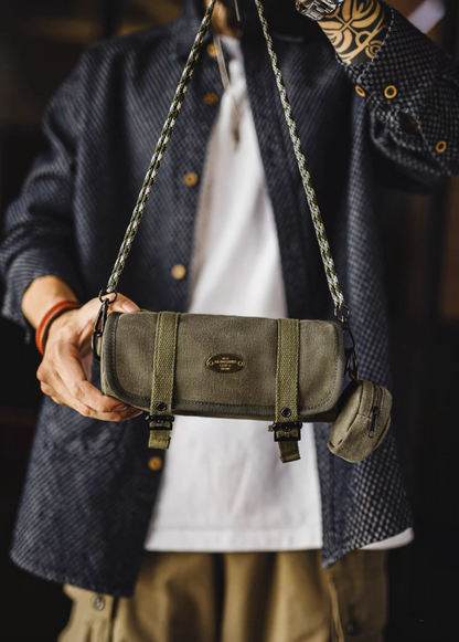 Model holding Ameikaji retro olive canvas crossbody bag with braided strap