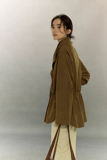 Side profile of caramel suede utility jacket showing soft drape and stand collar.