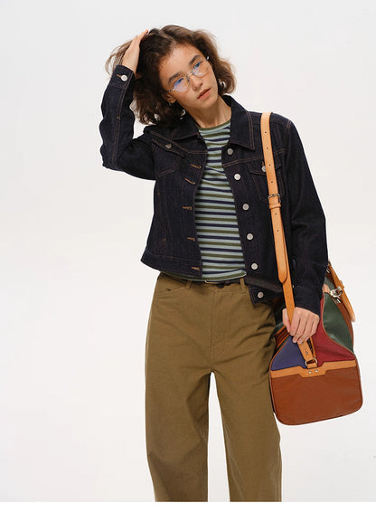 woman styling dark indigo denim jacket with striped shirt and khaki pants