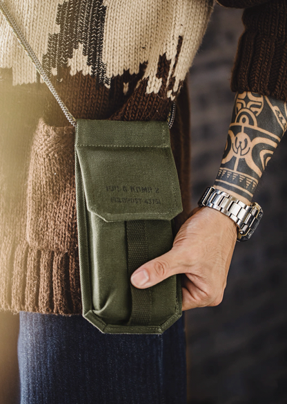 Model holding olive green M-16 Field Pouch Mini crossbody bag