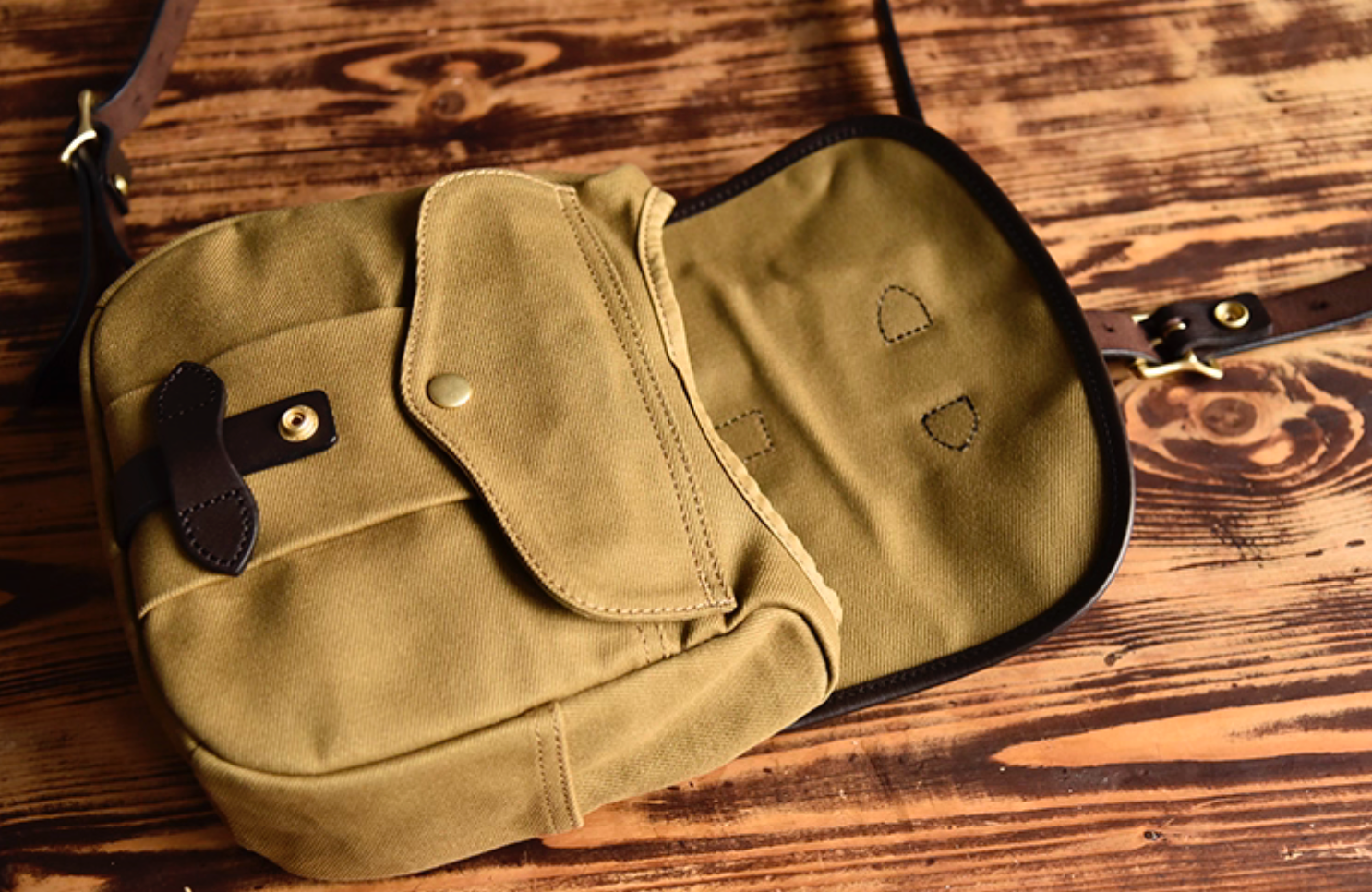 Inside view of Nomad Field Tan waxed canvas satchel showing pockets and flap.