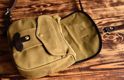 Inside view of Nomad Field Tan waxed canvas satchel showing pockets and flap.