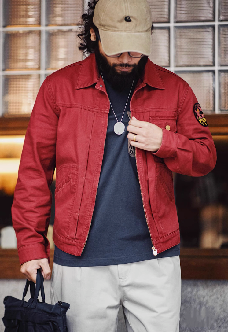 Front view of rust red embroidered rodeo jacket styled with beige pants