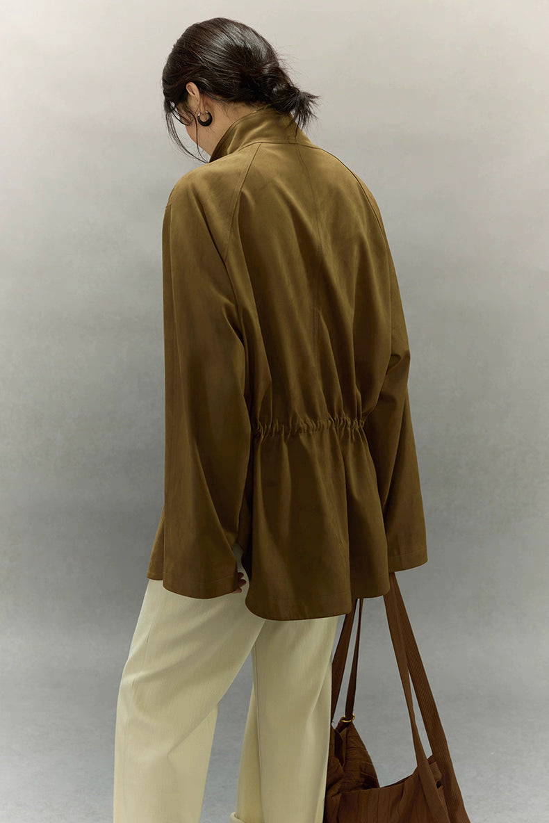 Back view of caramel faux suede jacket showing gathered high-waist detail.