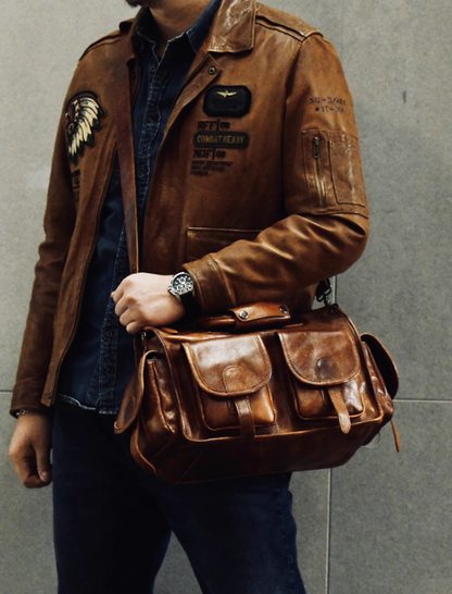Man wearing brown leather jacket carrying camel brown full-grain leather work bag
