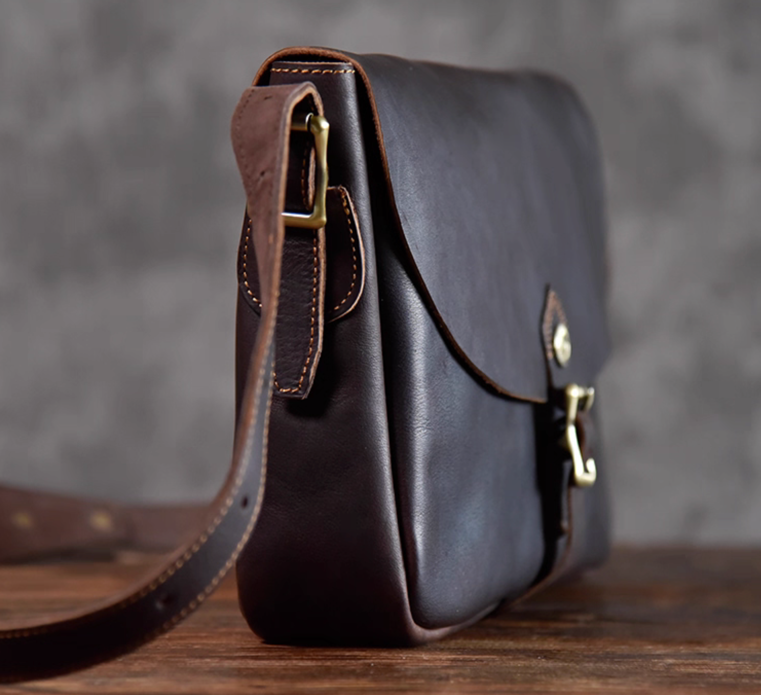 Side profile of the Italian full-grain leather crossbody bag highlighting clean stitching and slim shape.