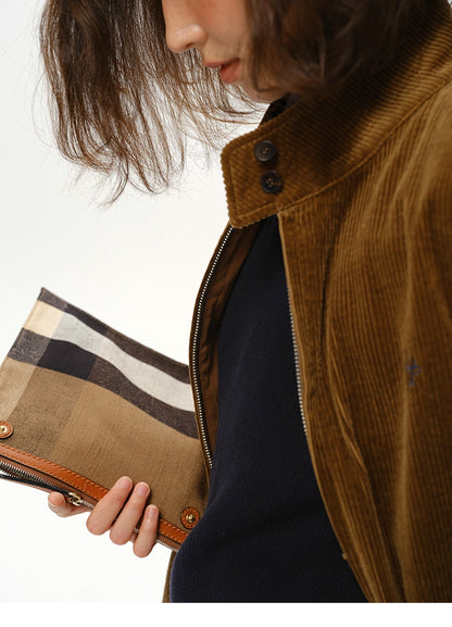 corduroy jacket detail shot with model holding clutch bag