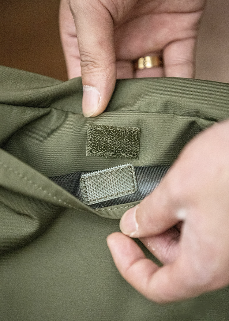 Close-up of Velcro closure system showing secure fastenings on the army green bag