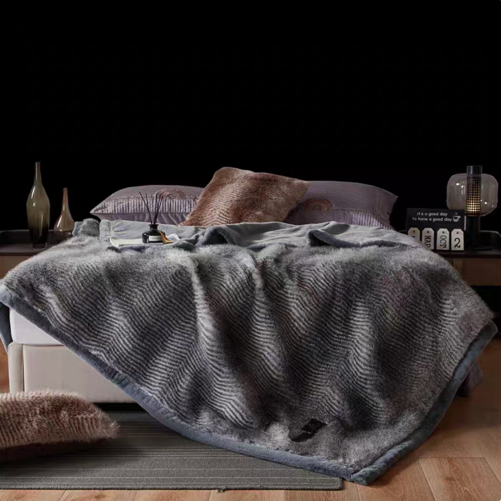 Patterned Gray long-pile faux fur luxe throw blanket styled on bed with soft striped gray texture