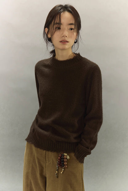 Model wearing dark coffee brown yak wool sweater with clean semi-high neckline.