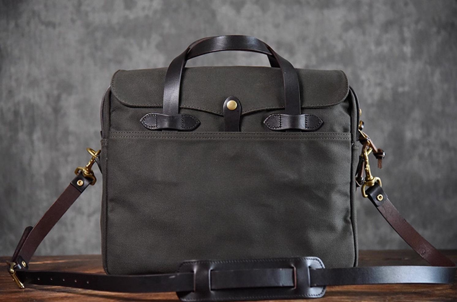 Charcoal black waxed canvas briefcase with brass hardware and leather strap
