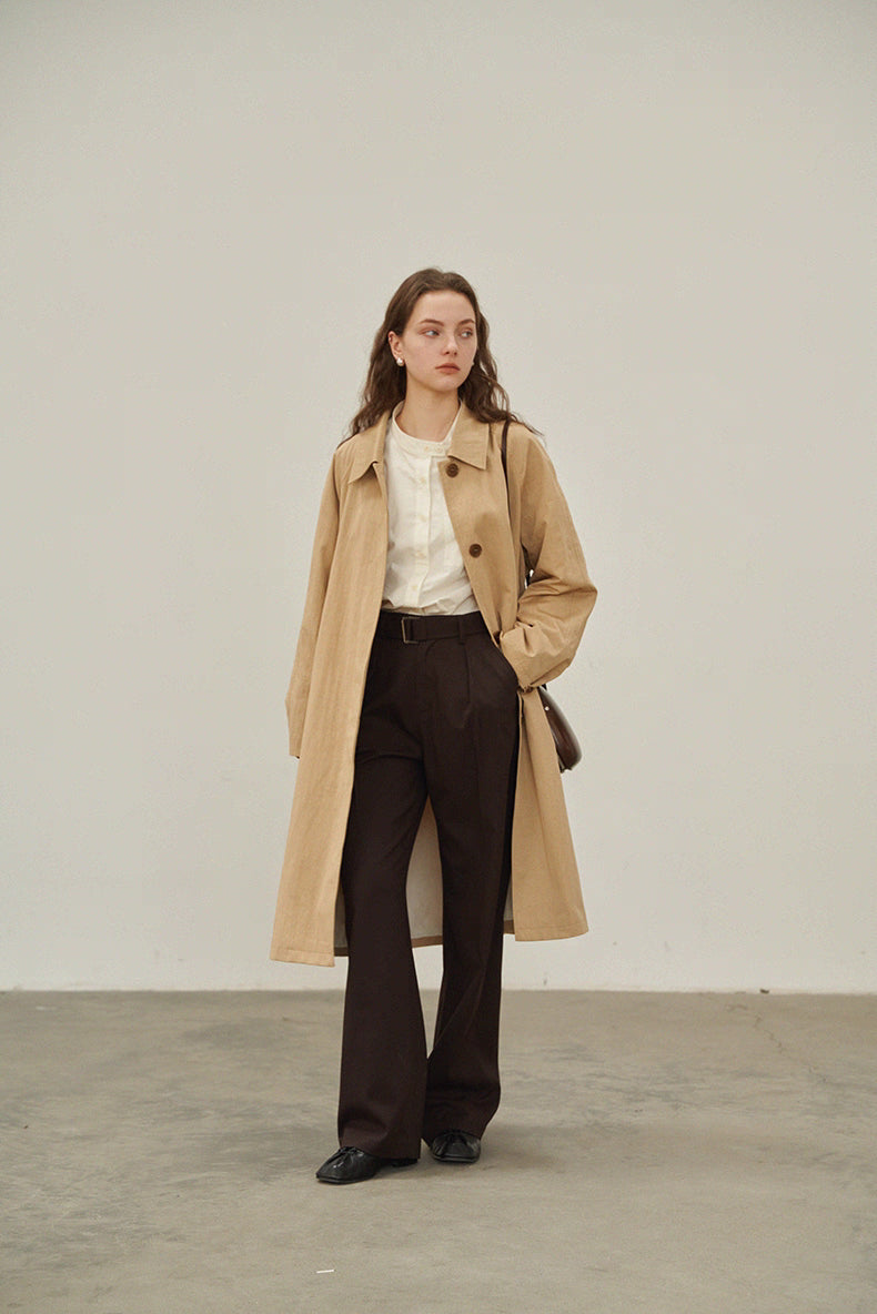 Full body view of beige khaki trench coat with relaxed A-line cut.