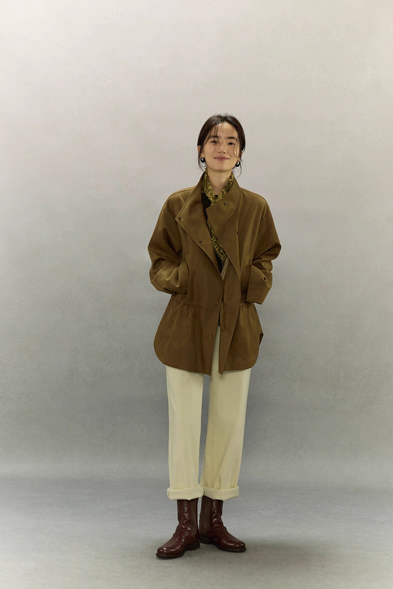 Full-body outfit featuring caramel suede jacket styled with cream trousers.