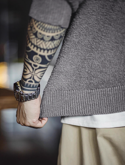 Close-up of sweater hem showing ribbed edge and textured fleece knit