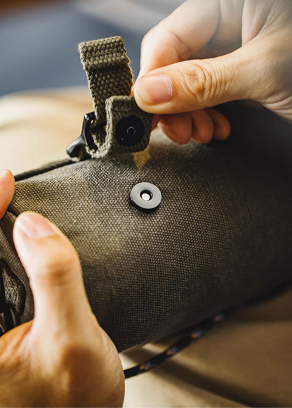 Close-up of magnetic buckle closure on Ameikaji tool roll bag