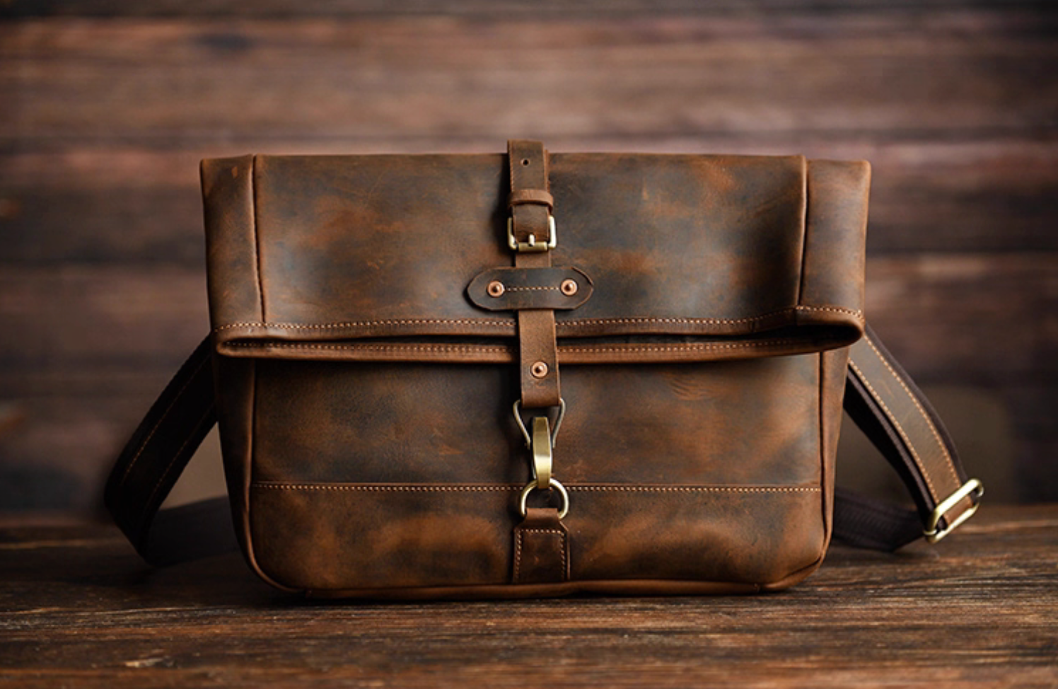 Front view of coffee brown version showing signature brass hook closure