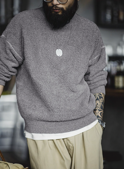 Close-up of sweater hem showing ribbed edge and textured fleece knit