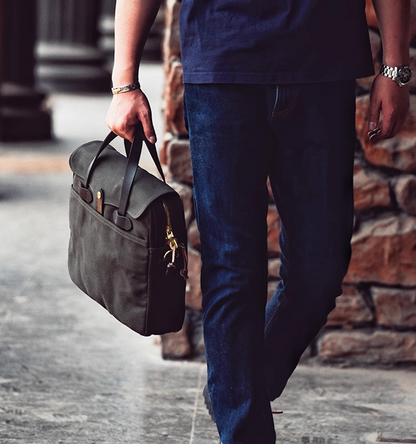 Man carrying charcoal waxed canvas laptop bag for work and travel