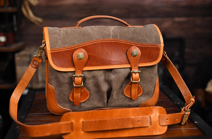 Angled view showing khaki grey and tan leather waxed canvas messenger bag