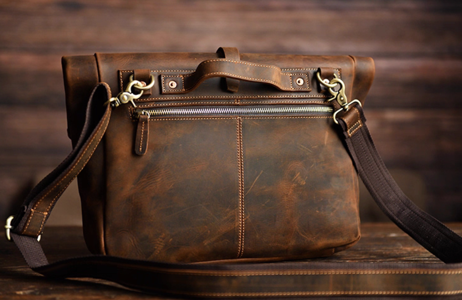Rear view of coffee brown crazy horse leather bag with zipper and handle details