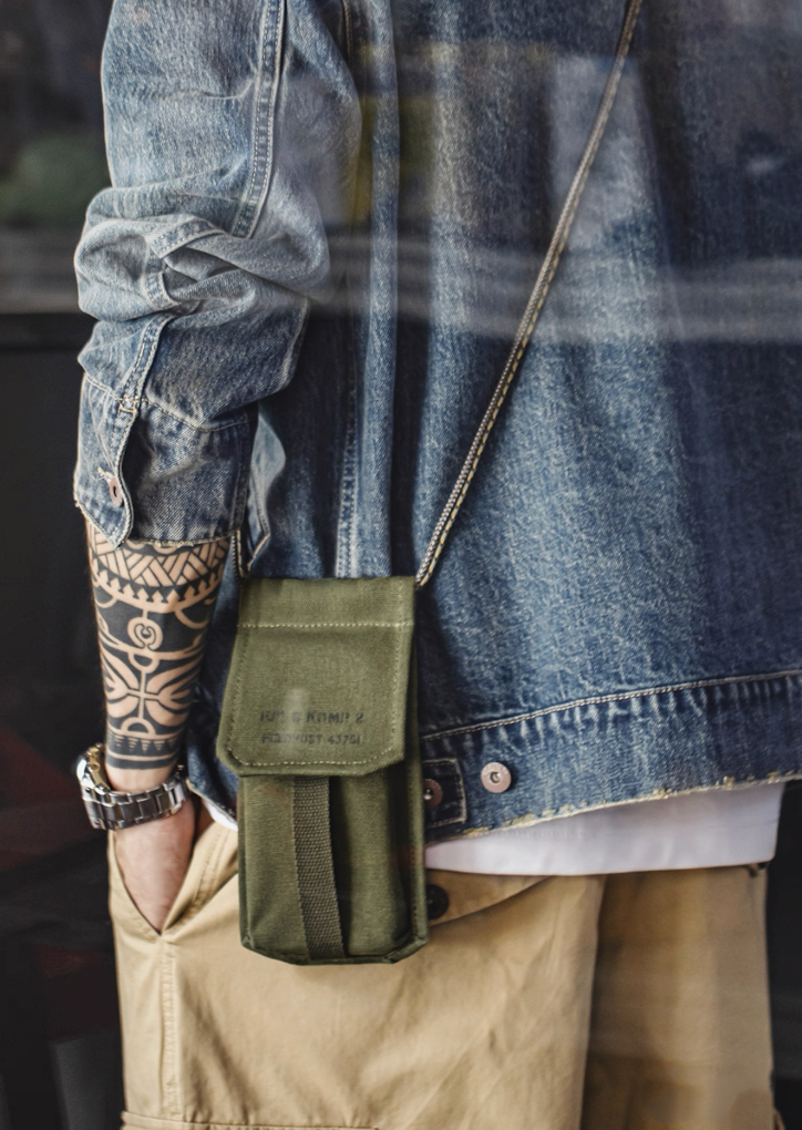 Model wearing M-16 Field Pouch Mini with denim jacket and khaki pants