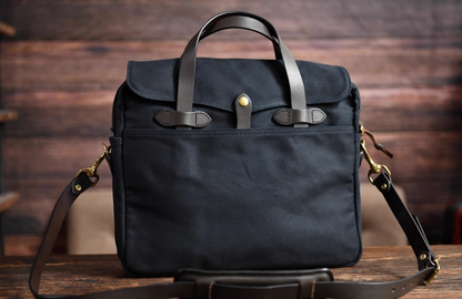 Navy blue waxed canvas briefcase with full-grain leather handles and strap
