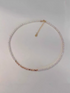 Delicate pearl strand necklace with gold-plated silver accents flat lay showing natural freshwater pearls with gold fragment details and adjustable chain