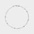 Elegant baroque pearl choker flat lay featuring irregular freshwater pearls in white and soft gray tones arranged on a minimalist silver chain