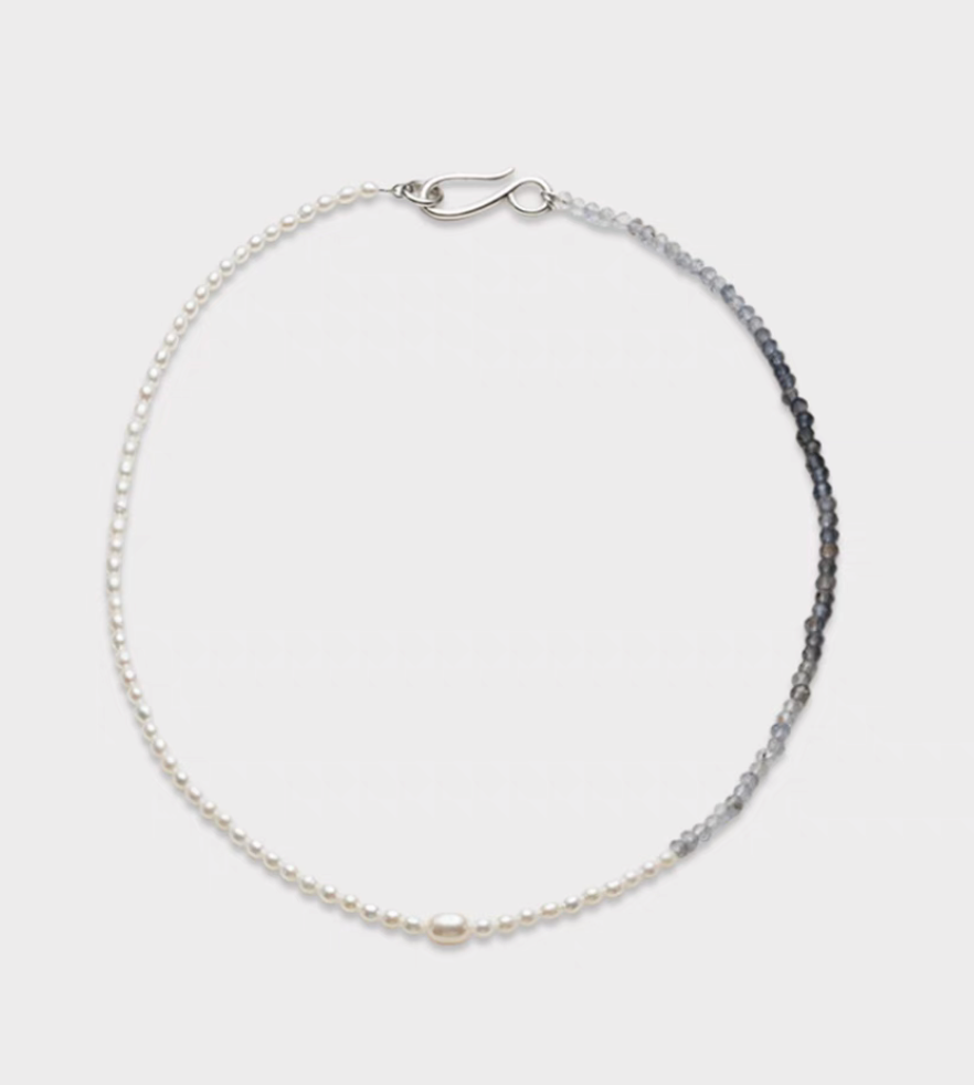 Harmony pearl and gem necklace flat lay featuring freshwater pearls on one side and blue gray natural stone beads on the other with a central pearl accent