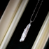 Organic baroque pearl drop necklace in silver displayed in black jewelry box featuring elongated irregular freshwater pearl pendant
