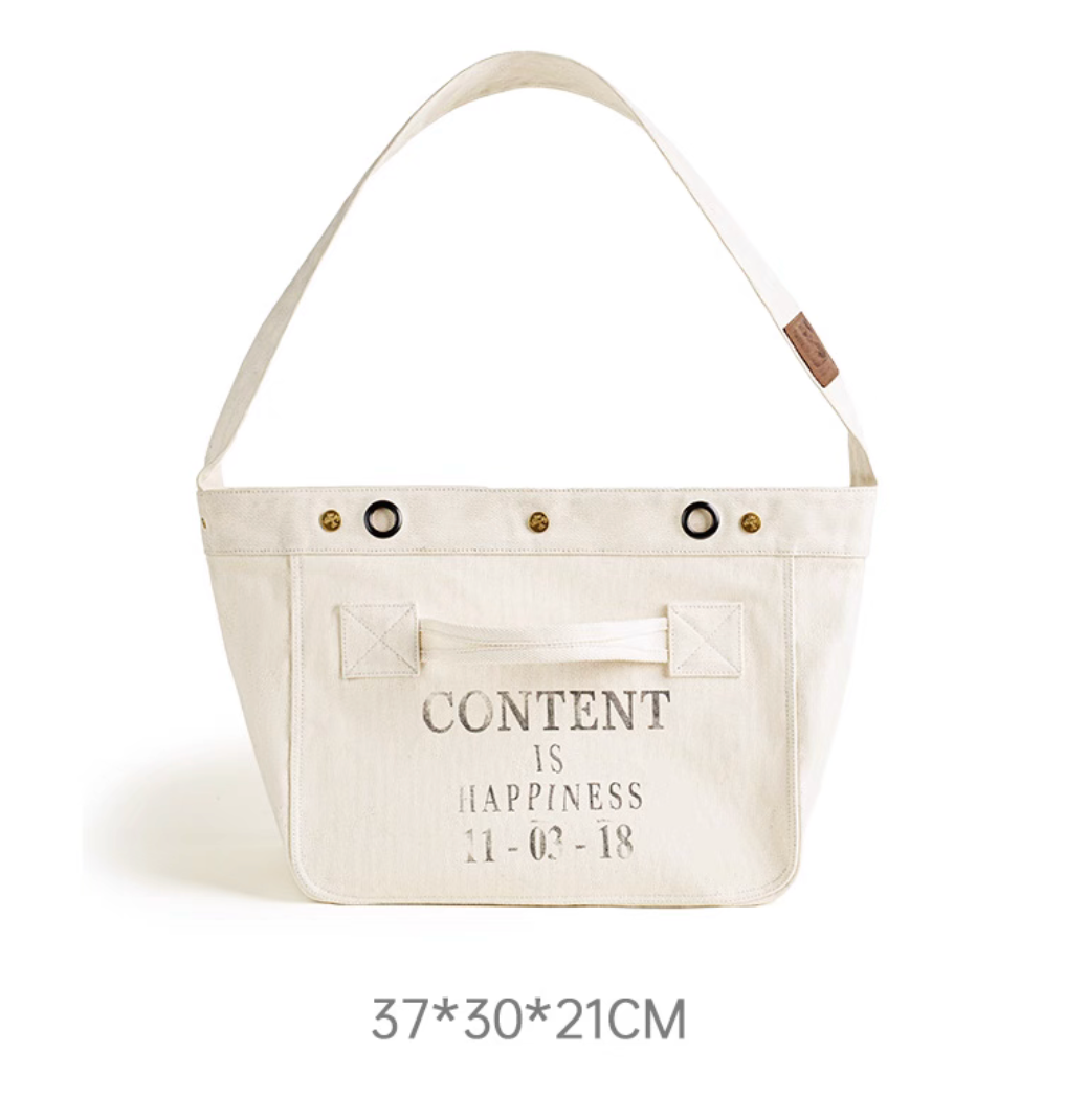 Retro canvas messenger bag front view with “Content Is Happiness” print