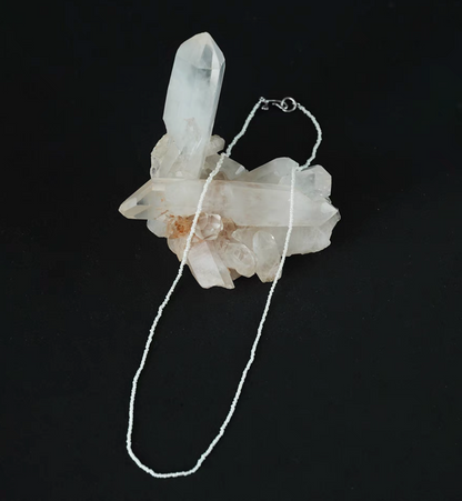 Wild pearl silver choker flat lay on crystal cluster featuring ultra-fine freshwater pearls with delicate minimalist silver clasp