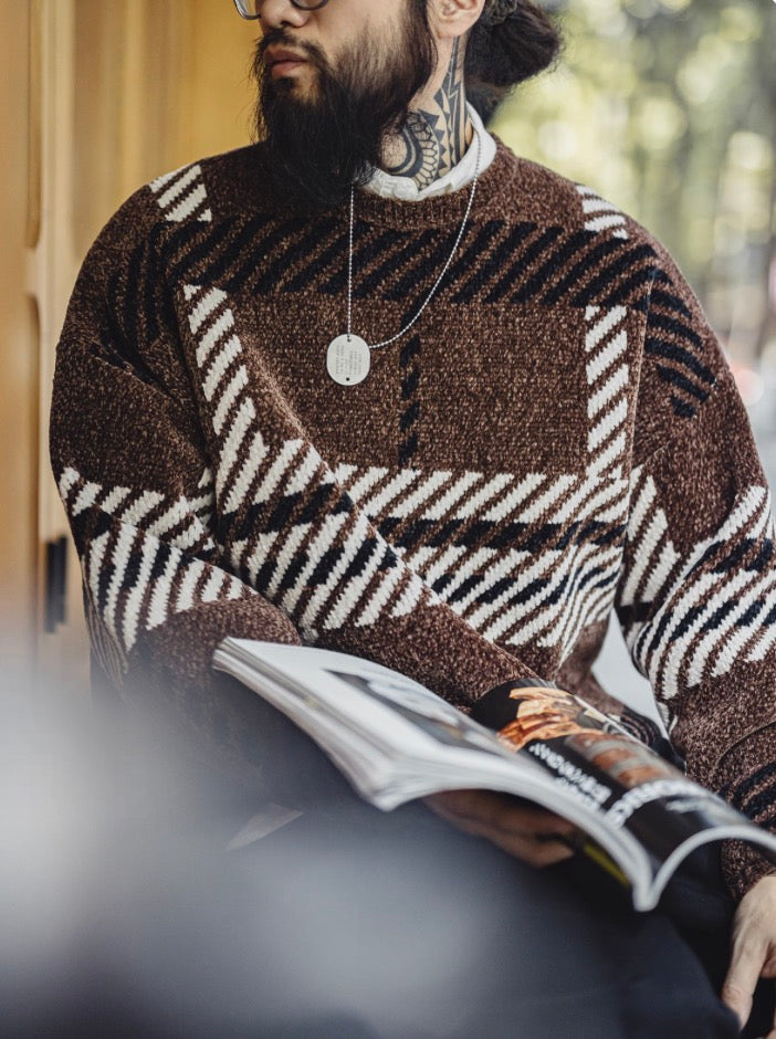 Men’s casual streetwear look in brown chenille plaid sweater reading magazine