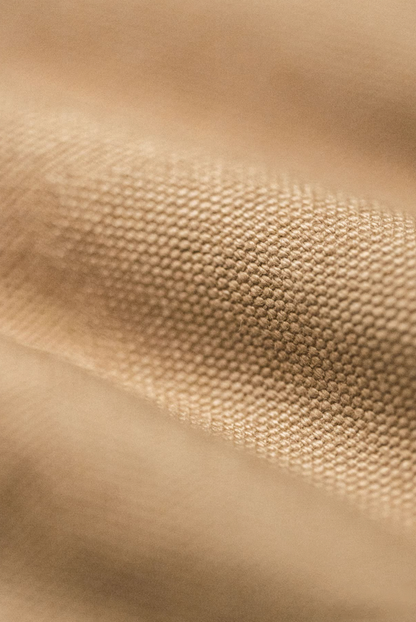Detailed close-up of heavyweight khaki canvas fabric texture of Santafe jacket.