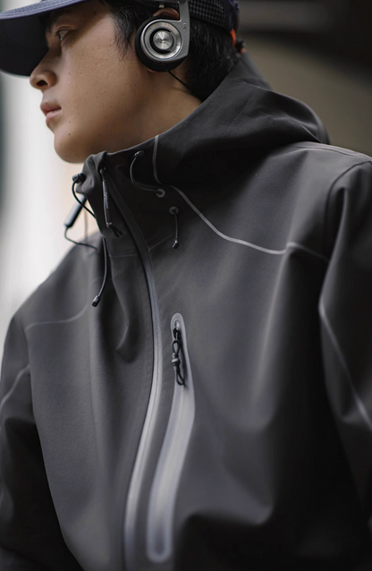 Side profile of model wearing grey LIGHTSABER Reflective Waterproof Tech Jacket