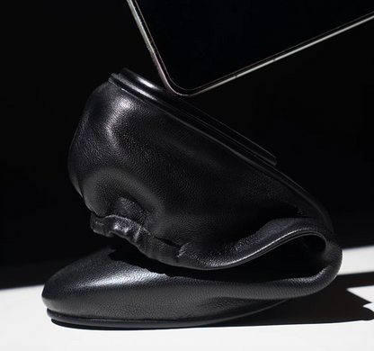 Black lambskin slipper loafer folded over to show its flexible, unstructured build