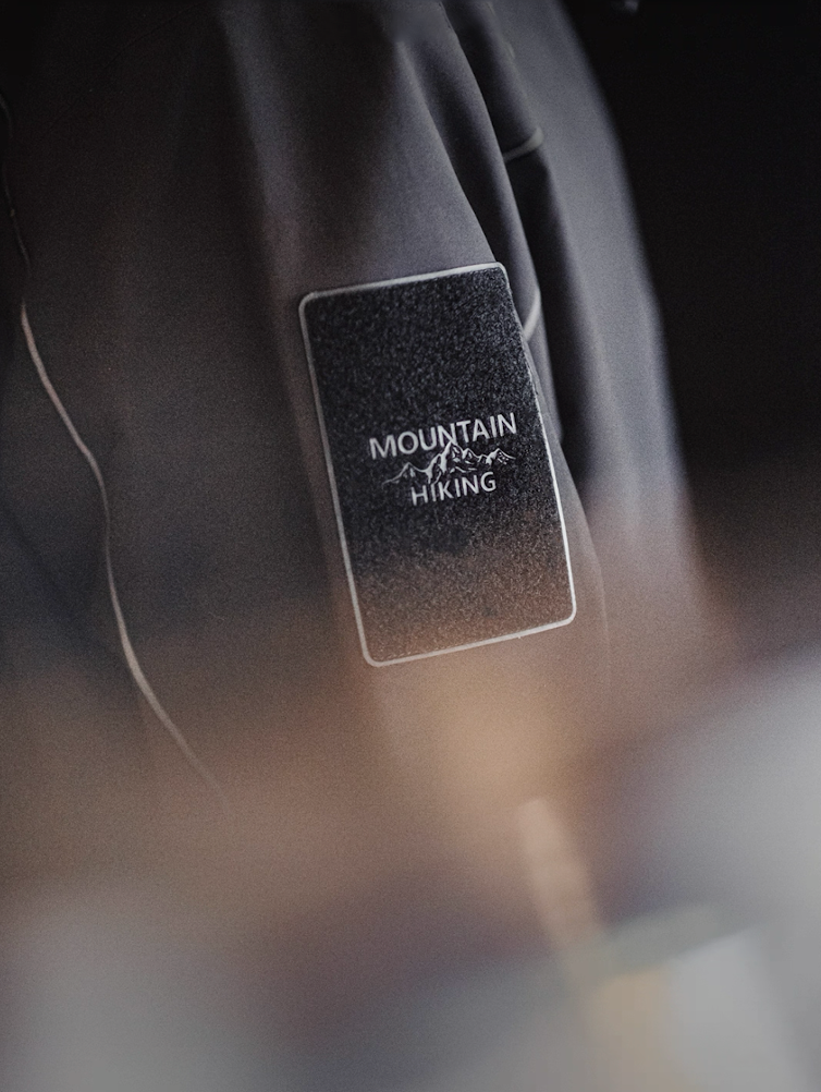 Arm patch with “Mountain Hiking” label on grey LIGHTSABER waterproof jacket