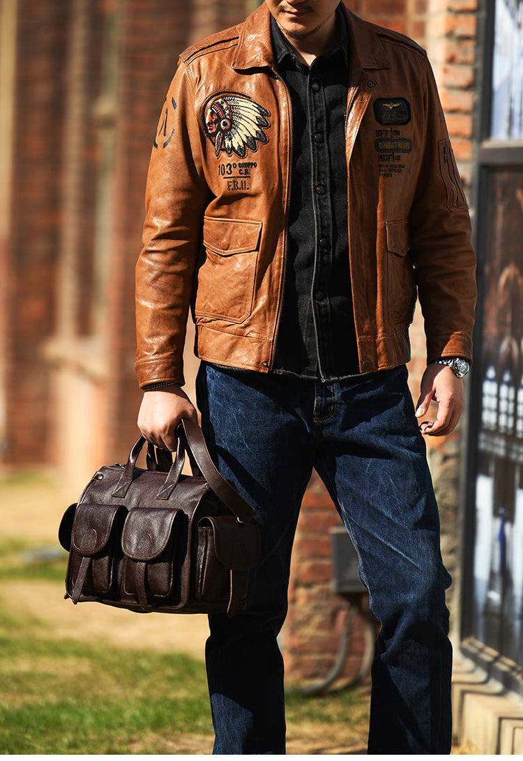 Man wearing tan leather jacket carrying dark brown full-grain leather work bag outdoors