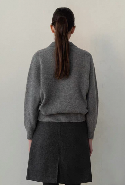 Close-up detail of cashmere wool polo sweater in dark gray with button placket