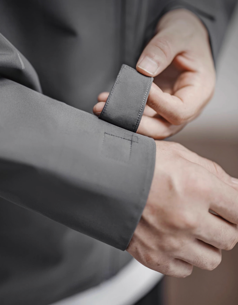 Adjustable wrist cuff strap detail on grey LIGHTSABER reflective tech jacket