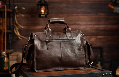 Rear view of dark brown leather travel bag with zip pocket and sturdy top handles