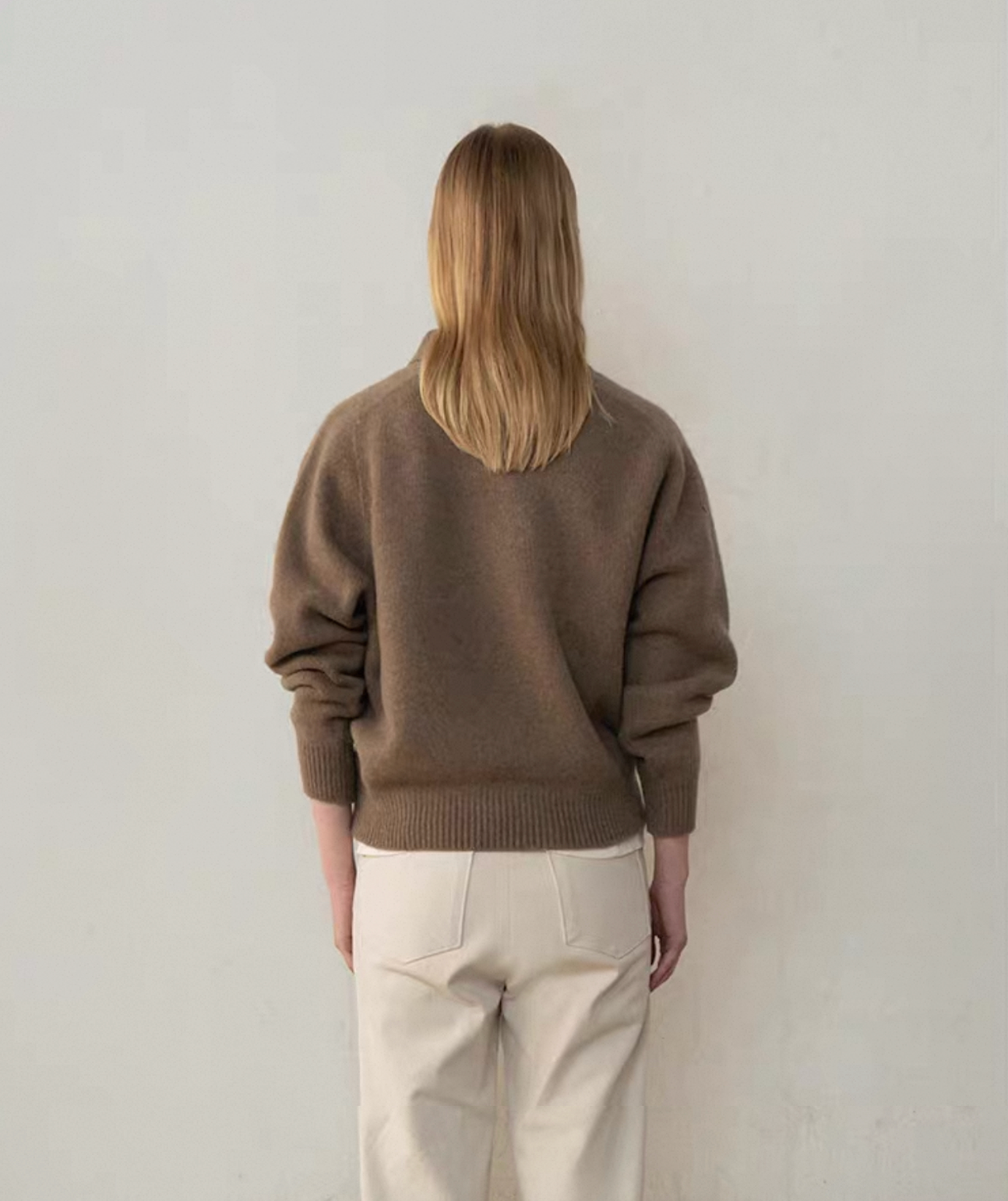 Side view of brown wool cashmere polo sweater with button placket