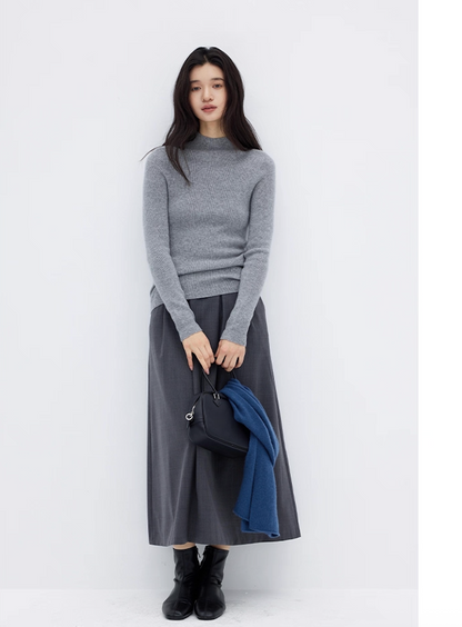 Full look with gray cashmere sweater and long pleated skirt, styled with ankle boots and navy scarf
